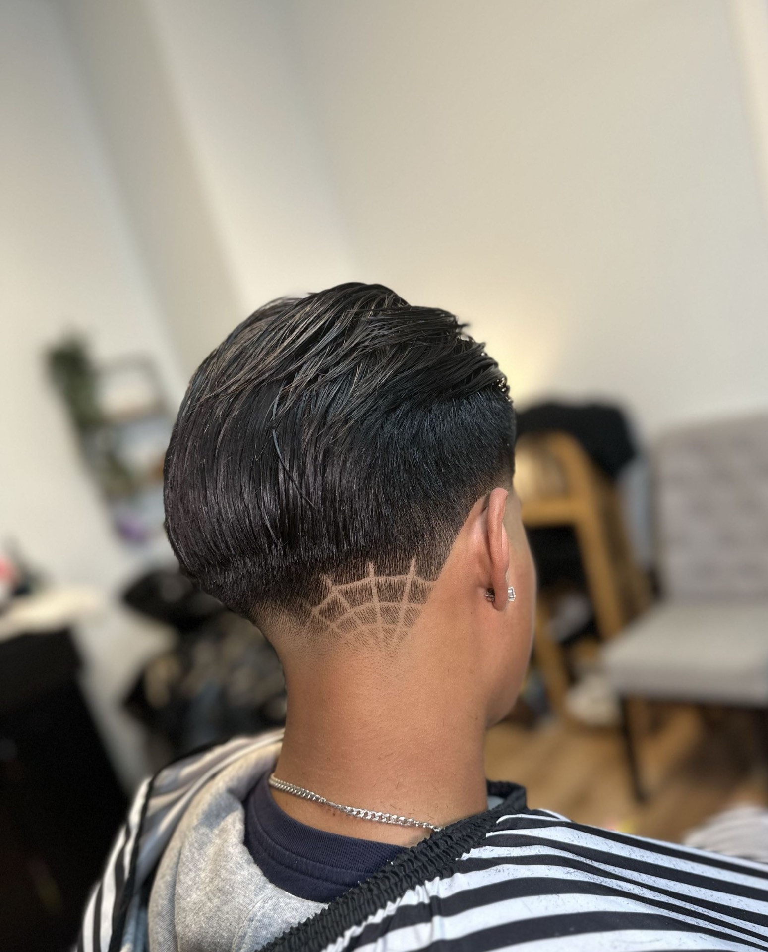 Slicked back top with spider web design